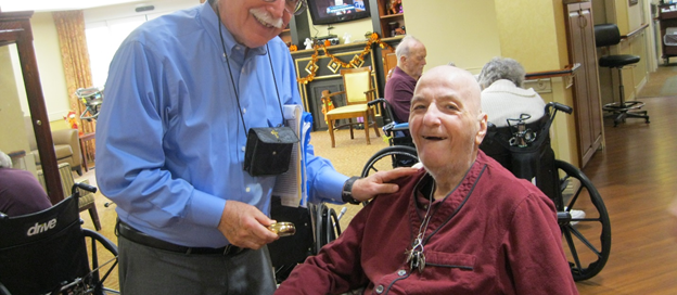 Paul-Casey-an Ignatian-Volunteer-Corps-member delivers the Eucharist at-the-Neighborhoods-of-St.-Elizabeth nursing and rehab facility.